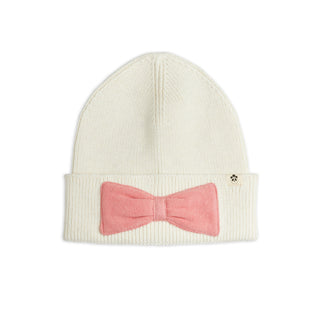 An off-white ribbed knit beanie hat featuring a pink bow-tie applique on the front cuff for kids at Design Life Kids