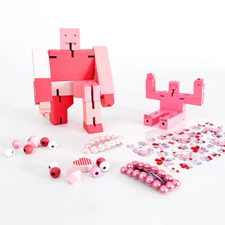 Areaware Cubebot Capsule, Cubebot Micro, Super Smalls Cit Chat Pearl Hair Clips, Good Luck Charms Sticker Sheet, and Cotton Twist Unicorn Wooden Bracelet Kit on DLK.