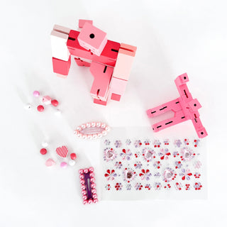 Areaware Cubebot Capsule, Cubebot Micro, Super Smalls Cit Chat Pearl Hair Clips, Good Luck Charms Sticker Sheet, and Cotton Twist Unicorn Wooden Bracelet Kit on DLK.